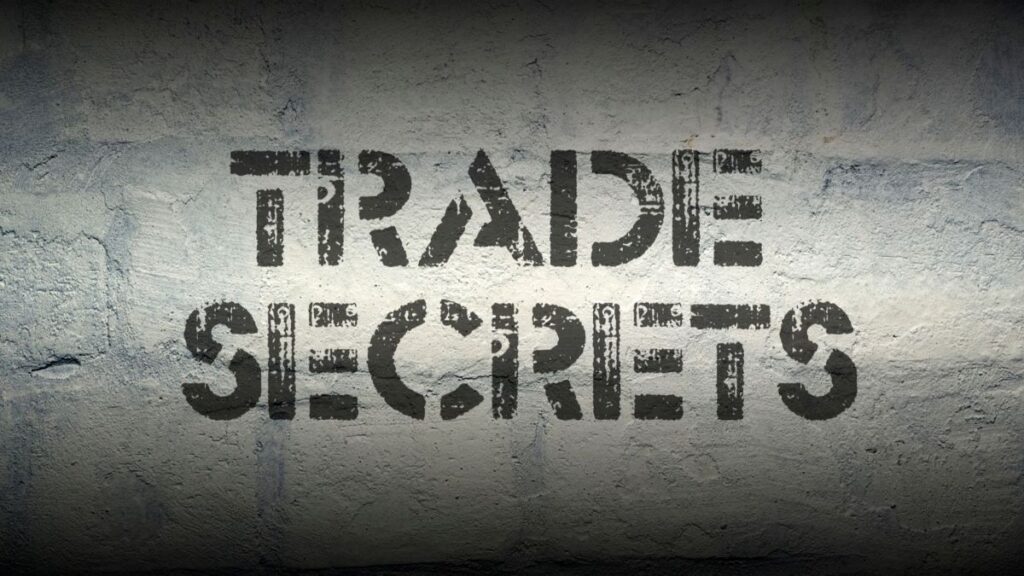 A concrete wall with Trade Secret painted on it.