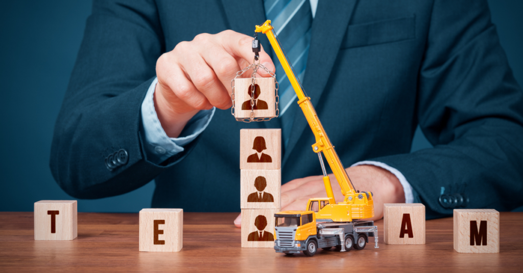 Building an Analytics Team in Your Organization. Part 2. A toy truck with building blocks that spell team.