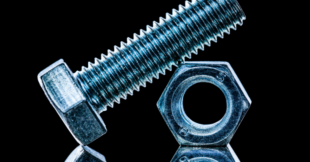 A nut and bolt on a black background. Representing why analytics id not a bolt-on business function.
