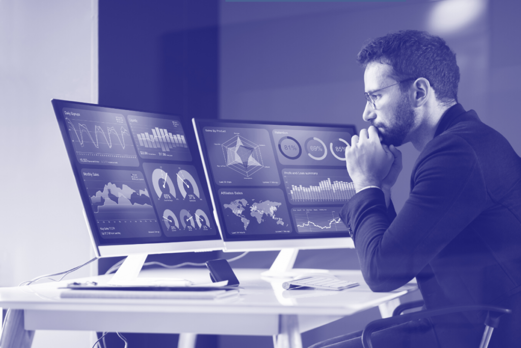 Concerned man sitting in front of computers