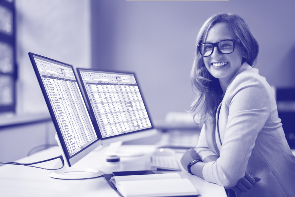 Smiling woman sitting at computer.