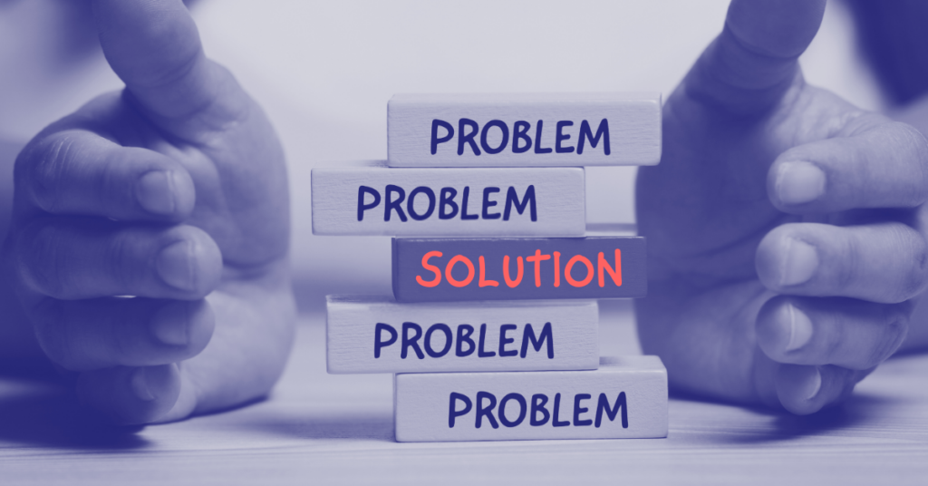 A pair of hands surround blocks imprinted with the word "problem". One block in the middle is imprinted with the word "solution." Common Business Problems You Can solve with Data.